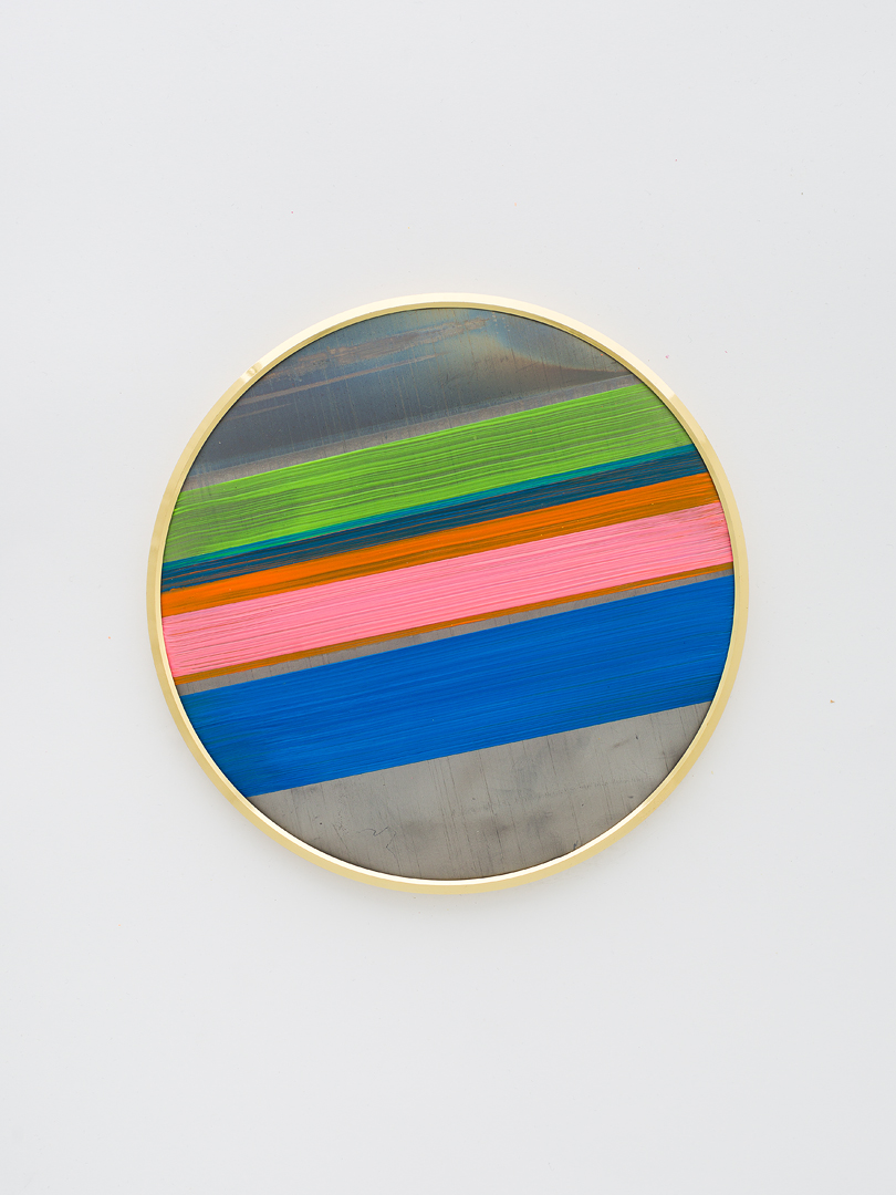 Golden framed, round painting on lead with thin and wide diagonal stripes in blue, light green, pink, orange. Grey lead stripe inbetwen.